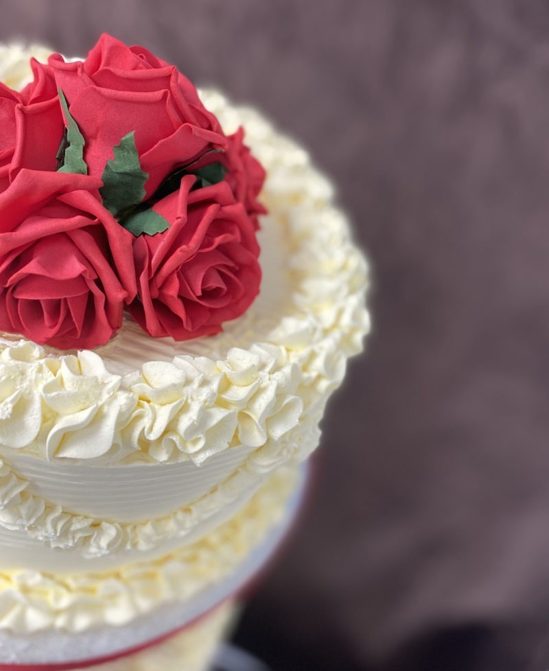 wed 8 scaled <div class="woocommerce-product-details__short-description" style="text-align: center;">3 Tier wedding cake on a stand with red flowers</div>